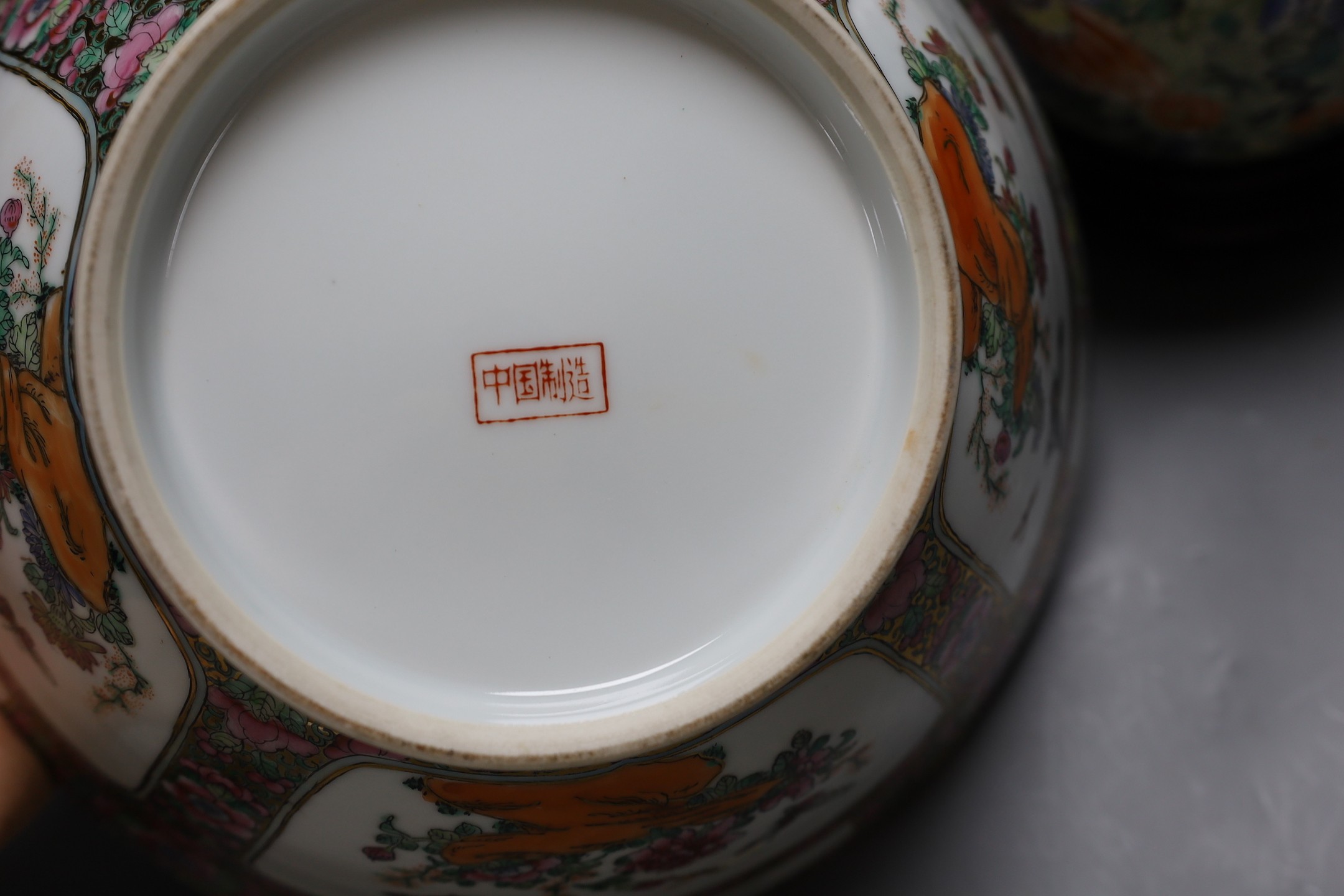 A Chinese famille verte vase converted into a lamp decorated with butterflies amongst botany, together with a famille rose punch bowl with quad-split panel decoration of floral landscapes, 31.5cm diameter